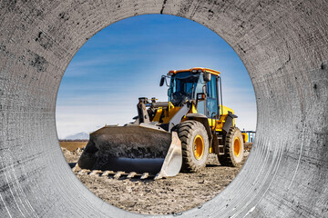 Powerful wheel loader or bulldozer working on a quarry or construction site. Earthworks in construction. Powerful modern equipment for earthworks.