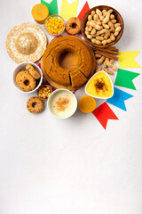 Festa Junina Summer Festival Carnival concept. Brazilian straw hat, popcorn, peanuts and Corn Cake on White Wooden Background