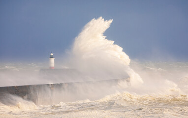 Storm Noa and crashing waves at Newhaven lighthouse and seawall on the East Sussex coast south east England