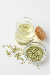 Top view of  fennel essential oil and fennel seeds in glass containers isolated on white