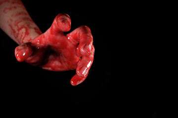 bloody hand on a black background, the concept of self-defense, murder, nightmares, halloween - obrazy, fototapety, plakaty