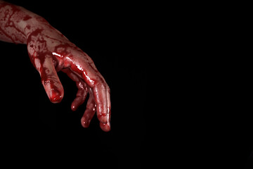 bloody hand on a black background, the concept of self-defense, murder, nightmares, halloween. copy space for text - obrazy, fototapety, plakaty
