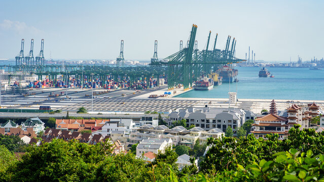 The cranes in the port of Pasir Panjang unloading containers from cargo ships passing by Singapore on the way to the Straits of Malacca. 