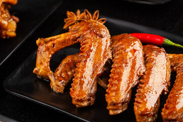 The duck's wings were boiled and placed on a  plate