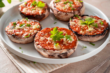 Stuffed champignon portobello, with tomatoes sauce and cheese. 