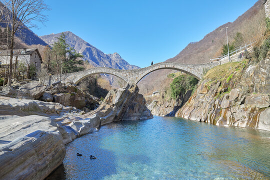 View of the medieval double arched bridge called Ponte dei Salti crossing the Verzasca river in the town of Lavertezzo, Switzerland.