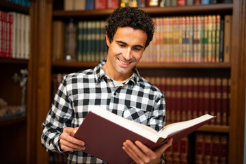 Smiling man reading a book