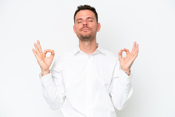 Naklejka premium Young caucasian handsome man isolated on white background in zen pose