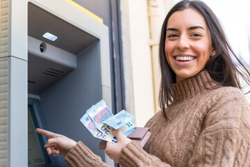Young woman using an ATM