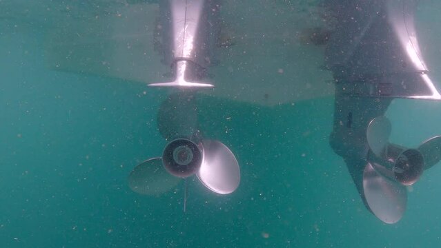 Under water film from Sail Rock island in Thailand - close up of two speed boat outboard engines - under water - ocean current slightly moving them around