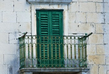 Fototapeta na wymiar Old balcony with green door vintage background