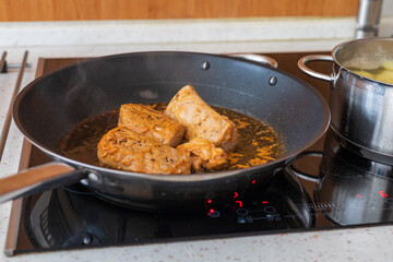 Pork tenderloin grilled on a pan. The doll is cut into pieces.