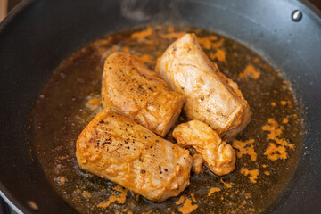 Pork tenderloin grilled on a pan. The doll is cut into pieces.