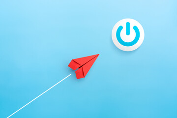 Start up business concept with power button and red paper plane on blue background