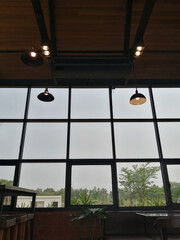 The cafe is airy with a tall glass interior. Incoming light reduces electricity consumption.