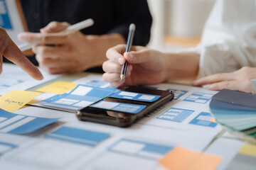 Creative digital development agency. developer team brainstorming on their project with laptop, smartphone and digital tablet.