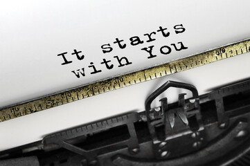Text It starts with You typed on retro typewriter