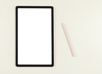 flat lay of digital tablet with blank white screen and pink stylus pen isolated on white background.