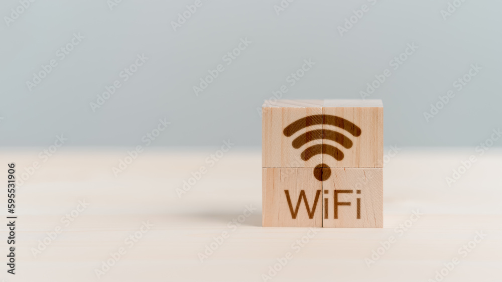 Poster Wifi icon on wooden cube block for service in the cafe. Business communication social network with wi-fi, Wireless network and connection technology concept.