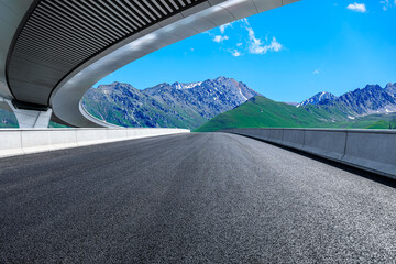 Asphalt road and bridge with mountain natural background
