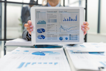 Businesswoman show tablet to display business graph