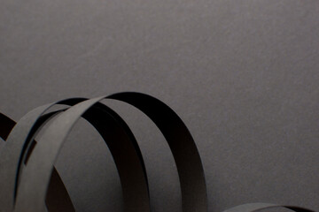 Black background with black 3d curved stripes, copy space