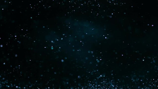 Slow motion of blue ink water explosion from above. Acrylic paint in water on a light black background. A powerful explosion of color. Filmed high speed cinema camera, 8K downscale, 4K.
