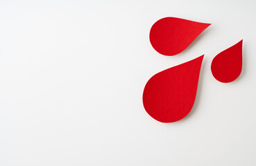 World donor day concept with paper red drop on white background