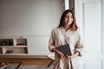 Businesswoman and work remotely. Positive pretty young caucasian lady in casual hold laptop, look at copy space