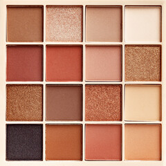 Fototapeta premium Eyeshadows palette as close up texture background Beauty product cosmetic powder for make up eye, beige brown color scheme, matte and shimmer tints. Aesthetic photo pattern, cosmetics