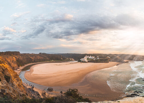 Odeceixe beach under the sun at sunset. The beauty of the Algarve region on the Atlantic coast of western Portugal. In the footsteps of the Fisherman trail. A dream tourist destination
