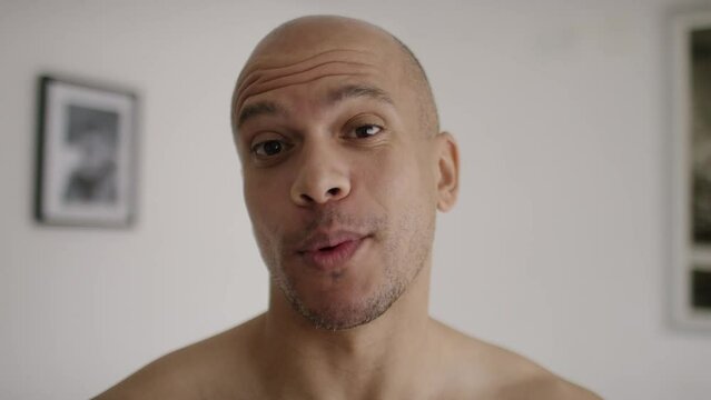 Handsome male talking to camera before blowing a kiss at the end