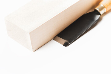 Sharp chisel with wooden bar for carving. Wood carving. Sharp incisors.