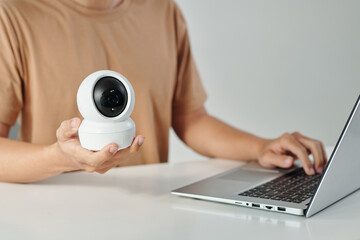 Man installing surveillance camera application on laptop