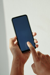 Closeup image of man using application on smartphone