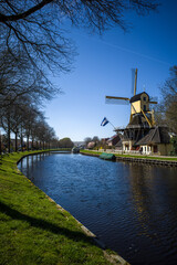 dutch windmill close to a canal