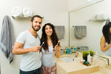 Attractive couple brushing their teeth together