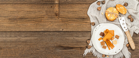 Norwegian brunost with cookies and nuts. Healthy food and eating, organic ingredient for breakfast