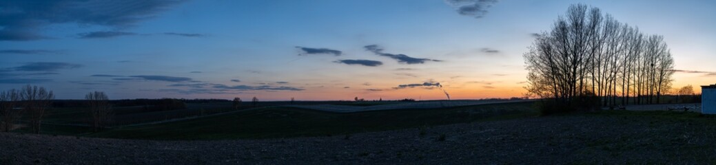 Evening farm shot with power plant in background