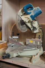 powerful chain miter saw in wood chips