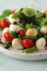 A plate with Italian salad caprese canape