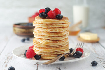 Pancakes with berries in rustic style