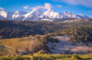 Beautiful morning spring landscape in the countryside. View of the Belianske Tatras from the village of Osturna in Slovakia.