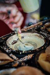 Apam balik is a Southeast Asian fluffy pancake with cream corn and peanuts. This soft pancake is usually made to order on street market.