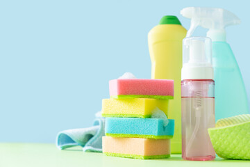 Obraz na płótnie Canvas Cleaning concept - cleaning supplies on pastel yellow background