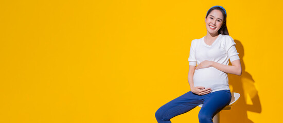 asian smiling positive facial expression pregnant woman touching her belly. Pregnancy health...