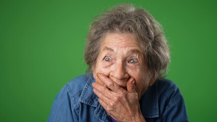 Closeup funny toothless portrait of elderly senior old woman with wrinkled skin and grey hair has...