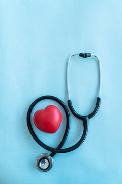 Statoscope with red heart shape isolated on light blue background with copy space for text, Medical and health care concept image
