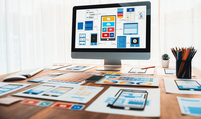 Digital and paper wireframe designs for web or mobile app UI UX display on laptop computer screen....