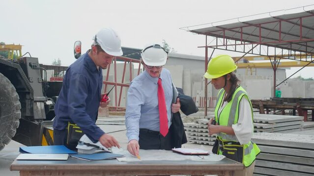 Team architect or engineer man and woman meeting for planning and strategy of development real estate at construction site, contractor and partner talking and looking blueprint, industrial concept.